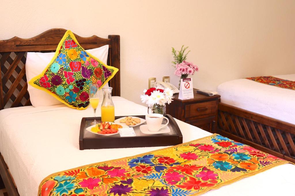 Colorful embroidered Mexican textiles and breakfast in a Camino Mexicano hotel room